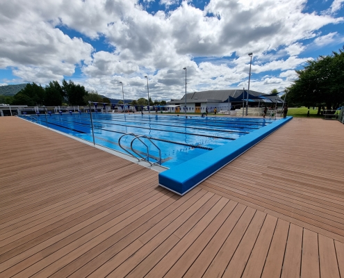 linear decking surrounding aquatic centre outdoor pool
