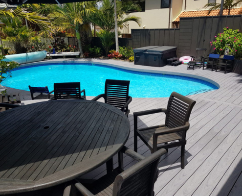 curved decking around small swimming pool